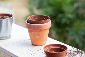 empty adn with ground ceramic and plastic pots