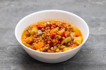 lentil with pepper, courgette and onion on white dish