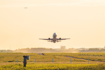 Naklejka na ściany i meble airplane take-off departure flight runway sunrise dust