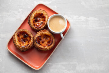 typical portugese egg tart pastel de nata with cupf of coffee