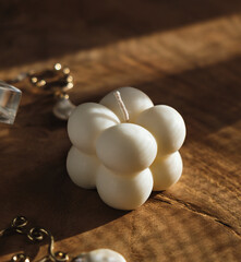 A trendy soy cube bubble candle on wooden table