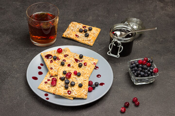 Biscuits with berries on gray plate.