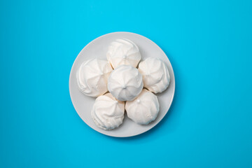 white small meringues on white dish