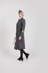 Woman actor reenactor in the historical uniform of the German army during World War II