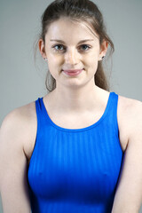 Portrait of a beautiful young woman wearing blue swimsuit in studio	
