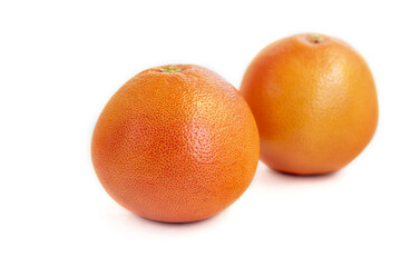 Grapefruit on a white plate with a sprig of mint. Isolate.