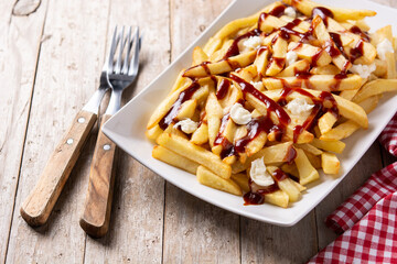 Traditional Canadian Poutine on wooden table	