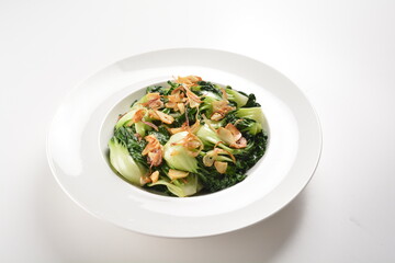 stir fried vegetable nai bai with garlic and mushroom in oyster sauce in white plate asian halal menu