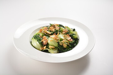 stir fried vegetable nai bai with garlic and mushroom in oyster sauce in white plate asian halal menu
