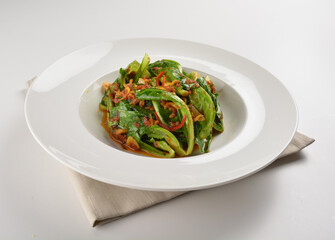 stir fried kai lan vegetable with spicy chilli sambal sauce in white plate asian halal menu