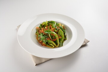 stir fried kai lan vegetable with spicy chilli sambal sauce in white plate asian halal menu
