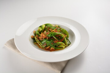 stir fried kai lan vegetable with spicy chilli sambal sauce in white plate asian halal menu