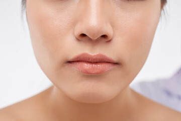 Obraz premium Close-up image of beautiful un young woman with flawless nude make-up and lip gloss