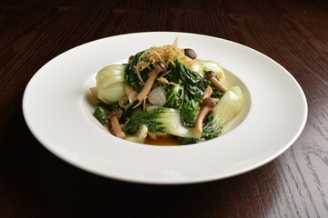 stir fried vegetable nai bai with garlic and mushroom in oyster sauce in white plate asian halal menu