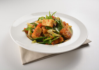 stir fried vegetable with bean curd tofu in spicy sambal chilli sauce in white plate asian halal menu