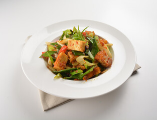 stir fried vegetable with bean curd tofu in spicy sambal chilli sauce in white plate asian halal menu