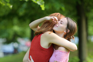Woman embracing friend holding her nose to avoid bad smell - obrazy, fototapety, plakaty