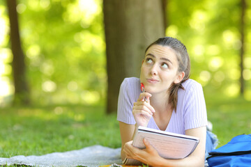 Pensive student wondering in a park