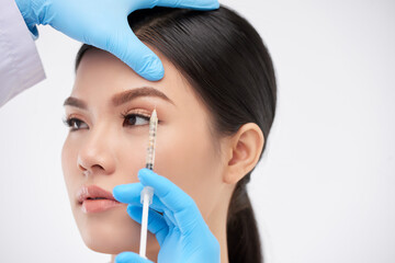 Young woman getting face injections to lift to brows and get rid of wrinkles