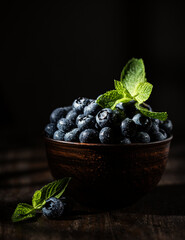 Freshly picked blueberries in wooden bowl