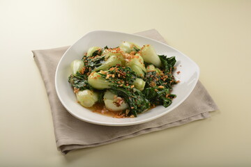 stir fried vegetable nai bai with garlic and mushroom in oyster sauce in white plate asian halal menu