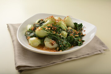 stir fried vegetable nai bai with garlic and mushroom in oyster sauce in white plate asian halal menu