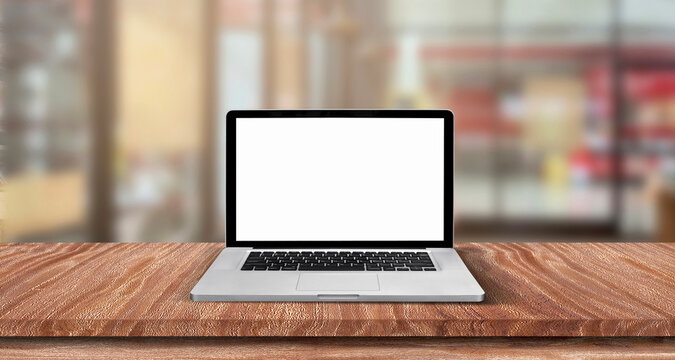 Top view of open laptop or notebook isolated on wooden table in soft blurry restaurant background. of free space for your copy, view from top.