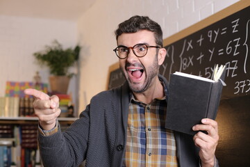 Angry teacher pointing with finger in classroom