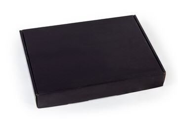 Closed black flat cardboard packing box on a white background