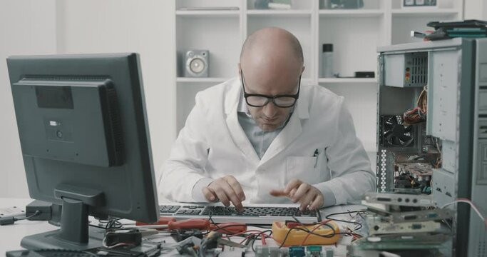 Angry technician working on a broken computer