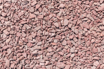 Section of ground covered with gray-red rubble, top view