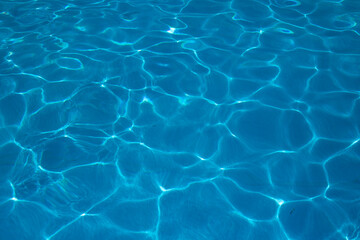 Fototapeta na wymiar blue water surface in the swimming pool, water in the pool. horizontal background for summer concept.