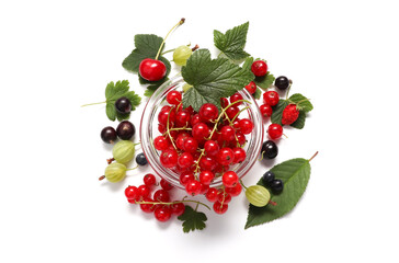 Ripe juicy summer berries of red currants, gooseberry, cherries, strawberries and blackcurrants with leaves, from above. The concept of summer berries, healthy food, berry assorted.