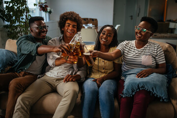 Happy group of friends making a toast at home gathering