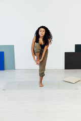 woman brunette engaged in yoga asana gymnastics flexibility