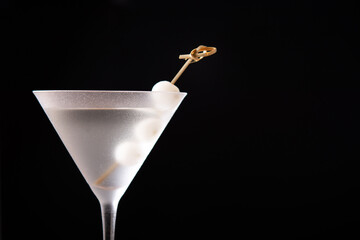 Gibson martini cocktail with onions on black background. Copy space