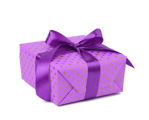 rectangular box wrapped in purple polka dot paper and tied with a silk ribbon on a white background