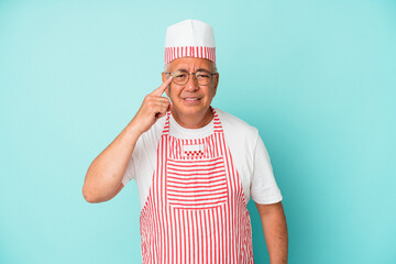 Senior american ice cream man woman holding isolated on blue background showing a disappointment gesture with forefinger.