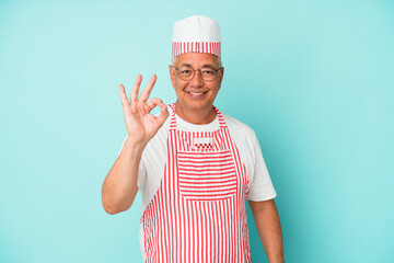 Senior american ice cream man woman holding isolated on blue background cheerful and confident showing ok gesture.