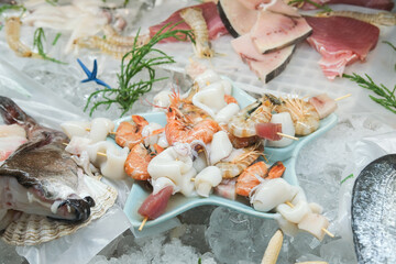 Fresh fish and seafood on the local market. Tuna, perch, shrimp, squid, langoustines on ice