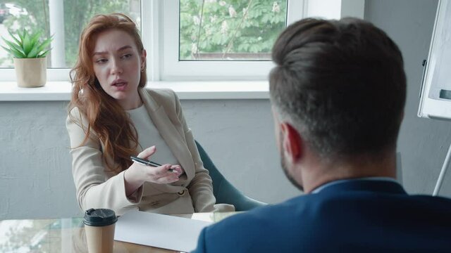 Businesswoman Interviewing Male Job Candidate In Meeting Room. Job HR applicants having an interview with Human resource manager jobs interviewing with confident candidate at business firm office.