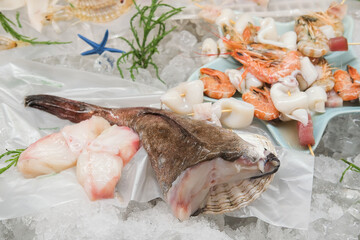 Fresh fish and seafood on the local market. Tuna, perch, shrimp, squid, langoustines on ice