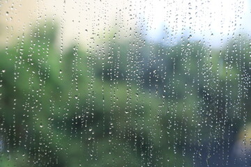 Close up of glass with rainy drops and blur background