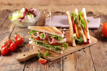 sandwich club with ham,  cheese and vegetables
