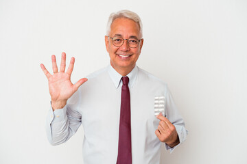 Senior american man holding pills isolated on white background smiling cheerful showing number five...