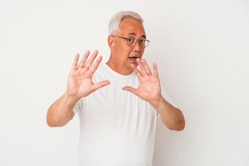 Senior american man isolated on white background being shocked due to an imminent danger