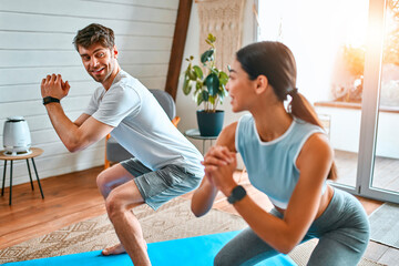 Young couple doing sports at home
