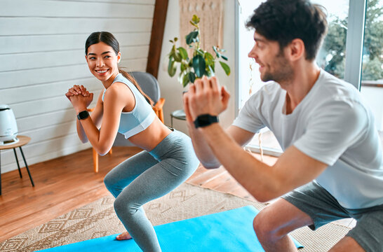 Young couple doing sports at home