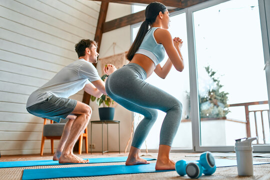 Young couple doing sports at home