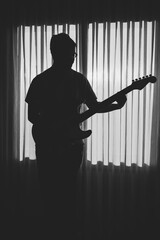 silhouette of a boy playing the guitar